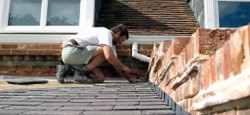 Roofer renovating chimney stack